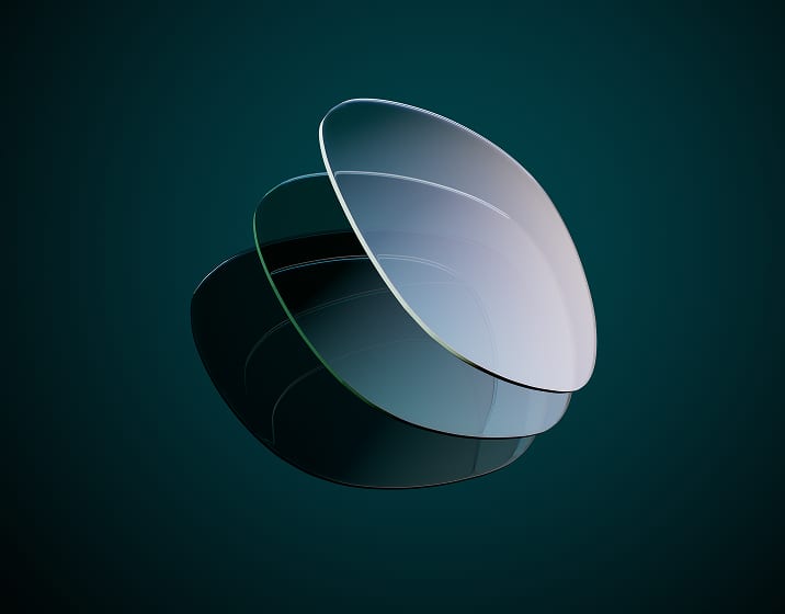A dark lens, a medium-dark lens, and a clear lens, representing the light-responsive properties of the EyeQLenz.