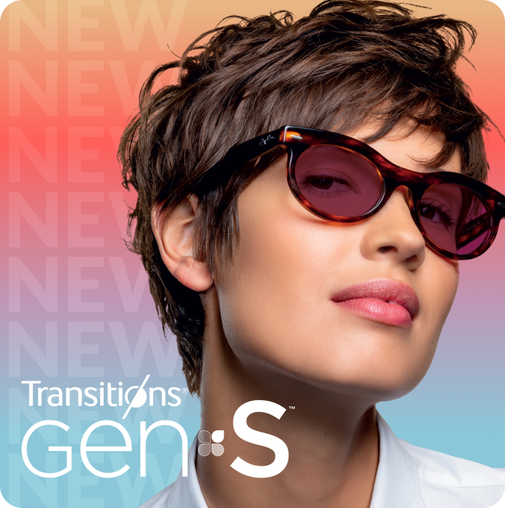 A woman in tortoiseshell glasses with ruby red Transitions Gen S lenses that change from clear to dark.