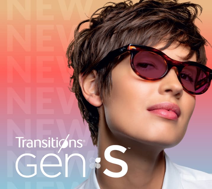 A woman in tortoiseshell glasses with ruby red Transitions Gen S lenses that change from clear to dark.