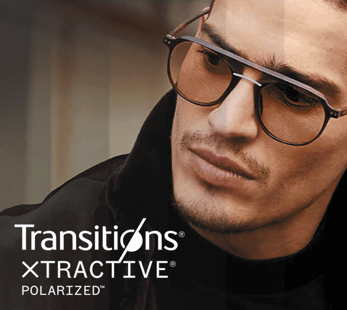 A man wearing aviator frames with Transitions lenses that go from clear to dark.