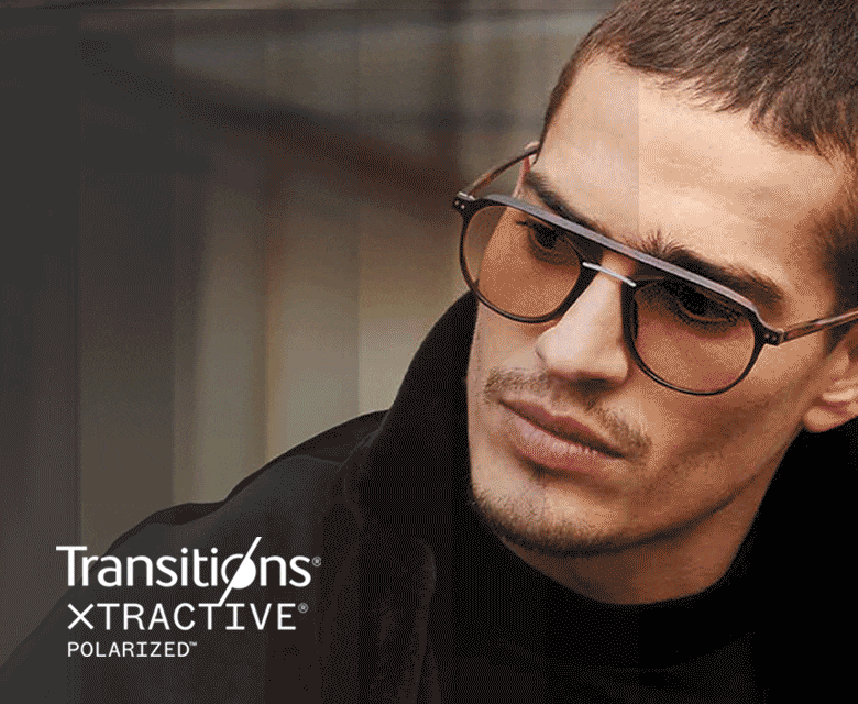 A man wearing aviator frames with Transitions lenses that go from clear to dark.