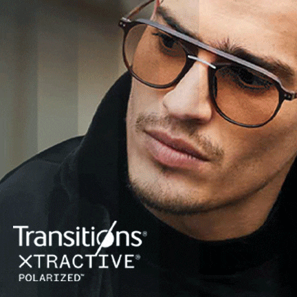 A man wearing aviator frames with Transitions lenses that go from clear to dark.