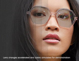 Woman in geometric glasses with Transitions® lenses that change from clear to dark.