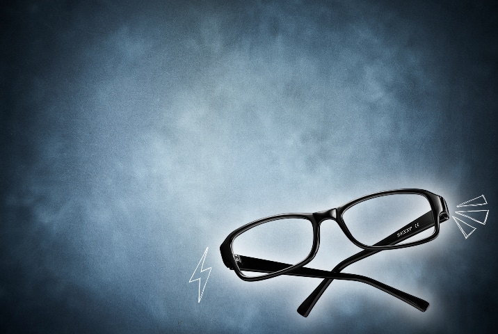 Black rectangular eyeglasses hovering on a textured slate blue background with white doodle accents including a lightning bolt and flash marks.