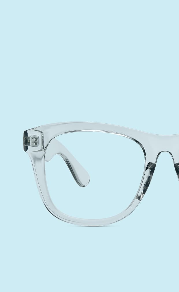 Transparent Zenni cat-eye glasses on a light blue background.