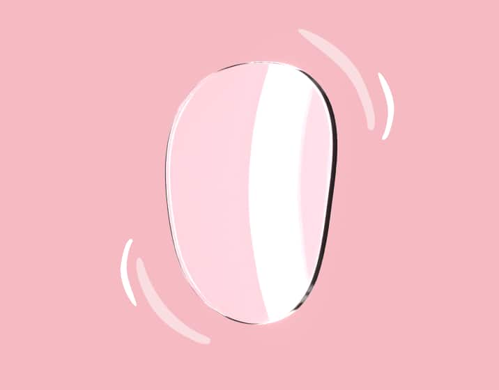 A clear Trivex lens on a pink background, turned slightly to profile, with illustrated curved lines around it to indicate its lightweight.