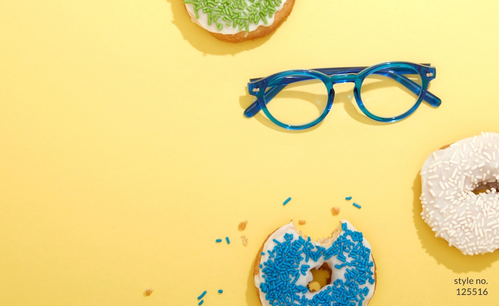 Image of a pair of Zenni round glasses #125516 against a yellow background, surrounded by three sprinkled donuts.