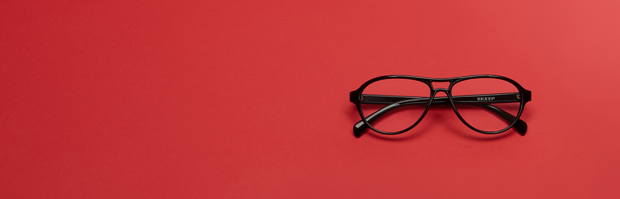 Image of Zenni black aviator #236021 on a red background.