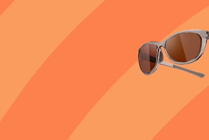 Translucent Zenni sports sunglasses with brown lenses. Orange stripe background.