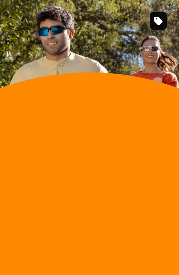 Two people jogging outdoors wearing Zunnies Sports Sunglasses under bright, sunny skies.