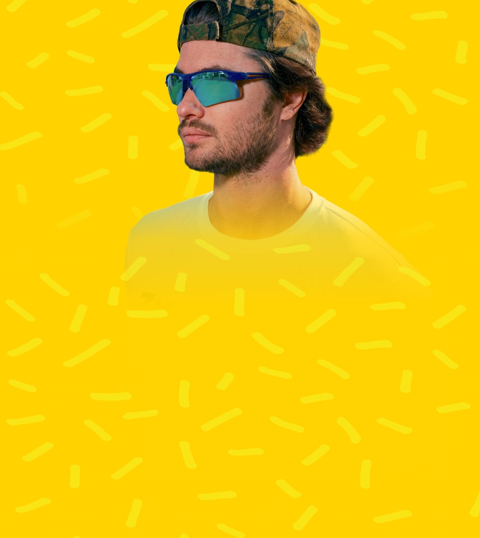 Chase Stokes wearing mirrored Zunnies sunglasses against a bright yellow background with playful graphic accents.