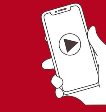 Illustration of a hand holding a smart phone with a video play button on the screen.