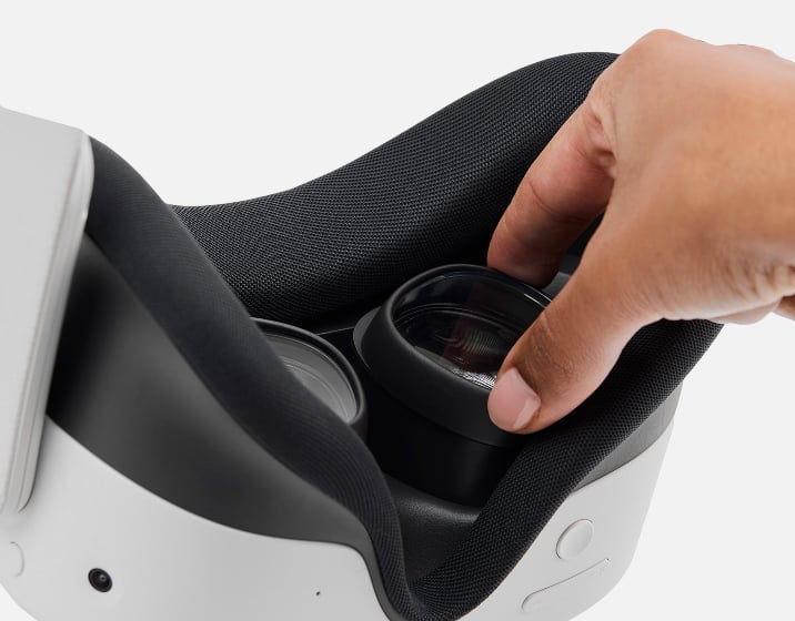 A hand inserting a Zenni VR lenst insert into a Meta Quest VR headset.