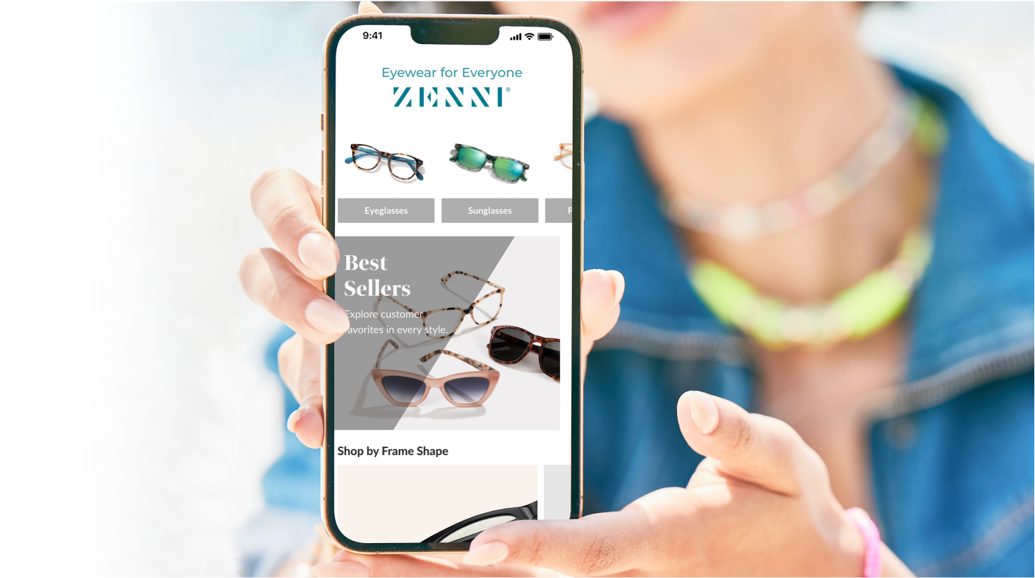Image of a person holding a phone with the Zenni app open. 