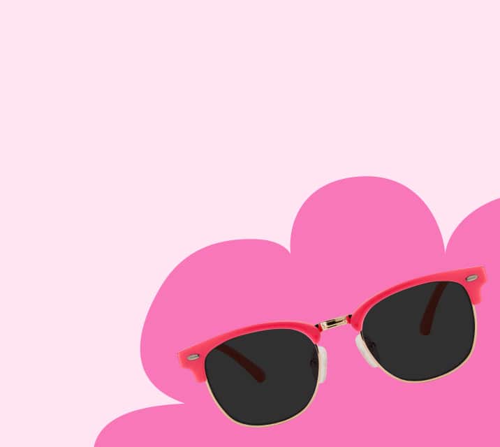 Red browline kids’ sunglasses with patterned temple arms on a pink background featuring a cloud shape.