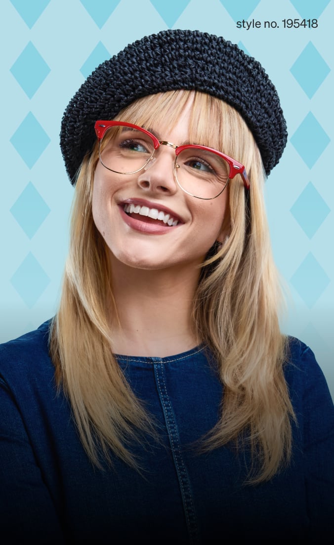 A smiling woman wearing red browline glasses and a textured black beret poses against a light blue diamond-patterned background. Style no. 502719