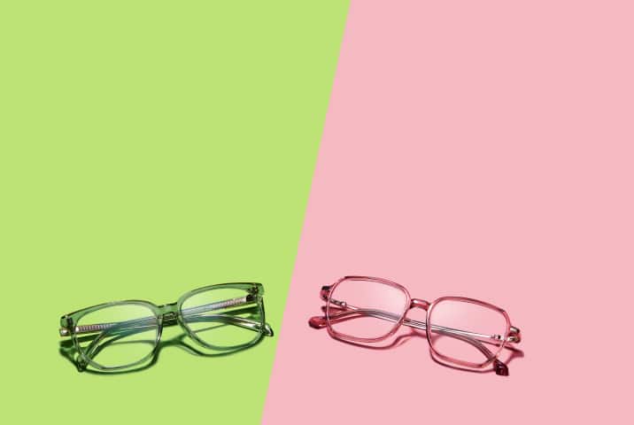  Green and pink Zenni eyeglasses styled with nail polish, lipstick, and flowers on a split-color green and pink background.