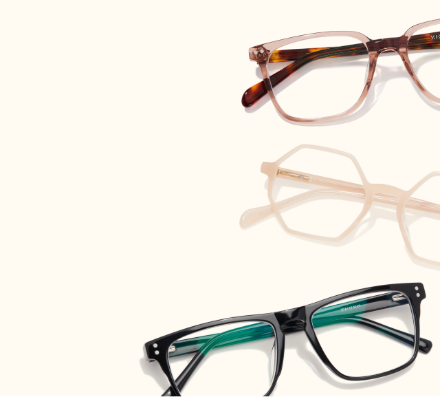 Several pairs of glasses of different frame shapes and colors resting on a beige background.