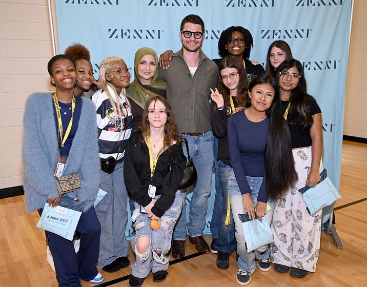 Actor Chase Stokes posing with students at a Zenni Optical event.