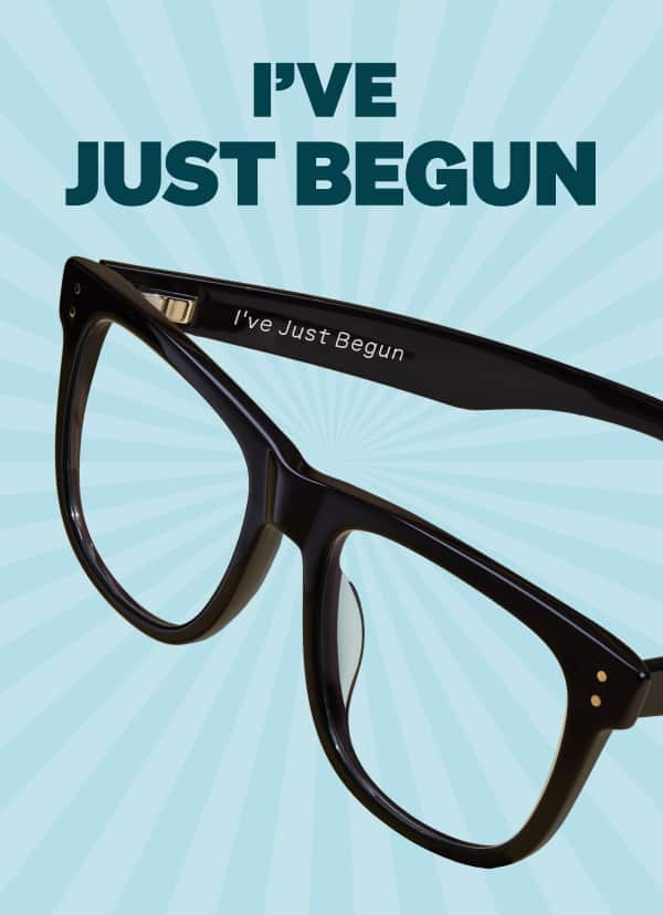 Black eyeglasses engraved with 'I've Just Begun' from Zenni’s Vision of Wellness collection supporting mental health.