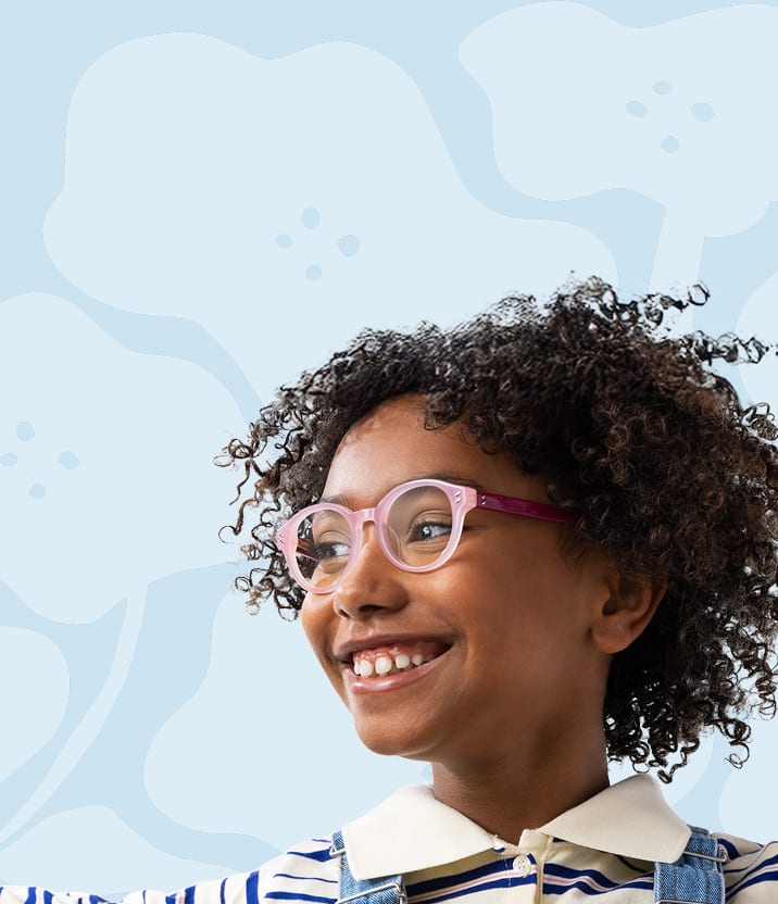 Young girl smiling in pink Zenni glasses, reaching up playfully with a soft, blue graphic background.