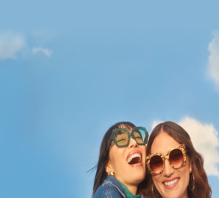 Banner image promoting FSA and HSA usage at Zenni Optical. Two women are smiling and wearing fashionable sunglasses, with a blue sky and clouds in the background.