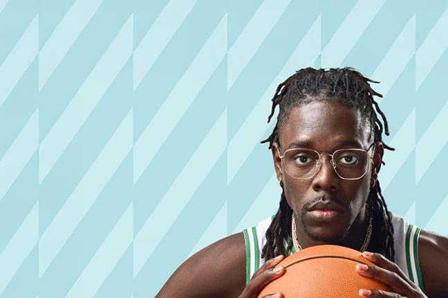 Jrue Holiday wears gold 'Hendrix' optical glasses from his Zenni collection, dressed in an NBA Boston Celtics jersey, holding a basketball against a teal-patterned backdrop.