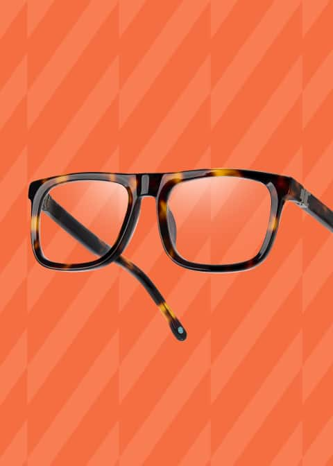 Zenni “Impact” optical glasses from Jrue Holiday’s collection float against an orange patterned background.