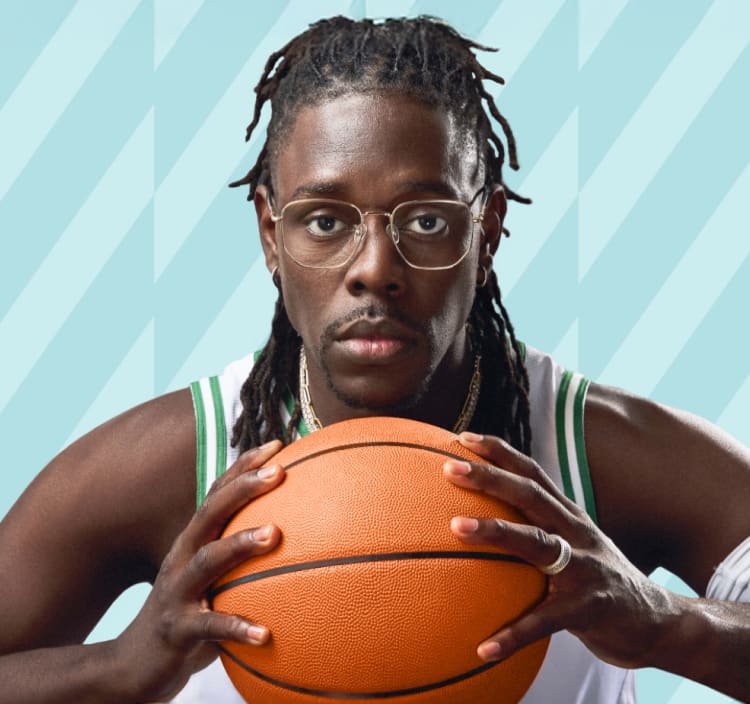 Jrue Holiday wears gold “Hendrix” optical glasses from his Zenni collection, dressed in an NBA Boston Celtics jersey, holding a basketball against a teal-patterned backdrop.