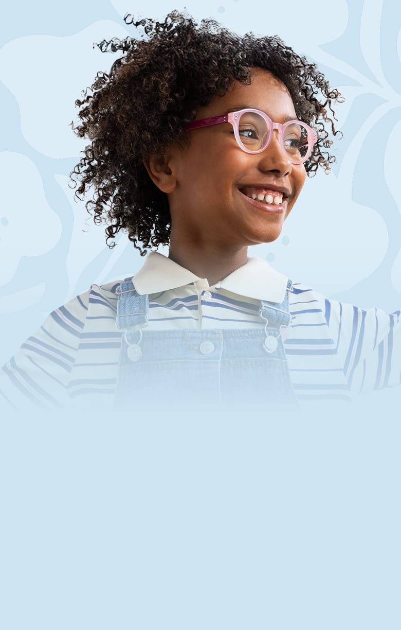 Smiling child wearing pink and purple eyeglasses from the Zenni Vision of Wellness collection, dressed in a striped shirt and denim overalls, with arms raised against a light blue background.