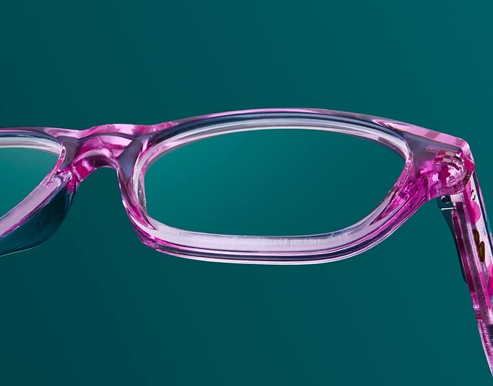 Polycarbonate impact-resistant clear lenses in a translucent square pink Zenni children’s frames.
