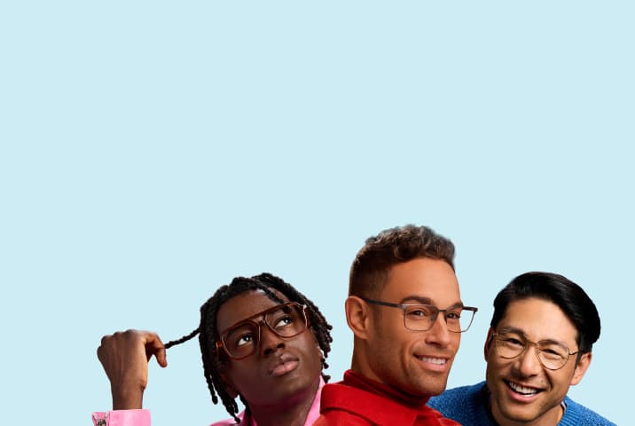 Group portrait of three men wearing prescription eyeglasses against a light blue background, featuring a man with dreadlocks looking up in translucent brown aviator frames, a smiling man in a red jacket wearing grey rectangular metal frames, and a smiling man in a blue sweater wearing thin gold wire aviator frames.