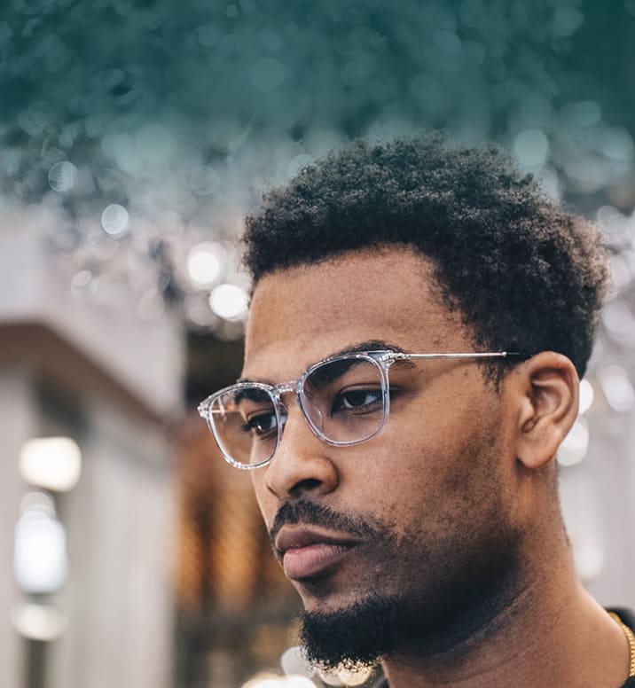 Man wearing Zenni clear rectangular glasses outdoors.