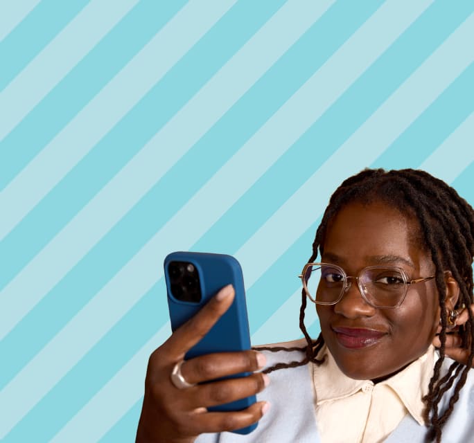 A woman with glasses looks at her phone against a light blue diagonal-striped background, promoting blue light filtering lenses. 