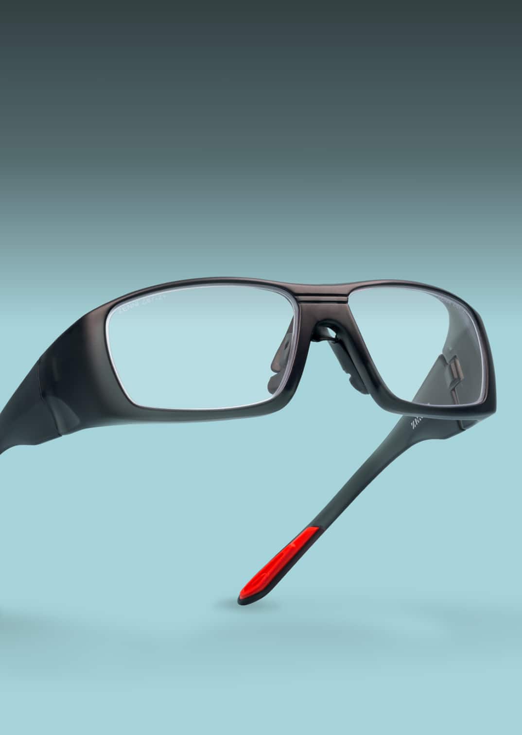 A pair of Zenni safety glasses with a red and black frame, accompanied by text promoting their protective features for work or DIY projects.
