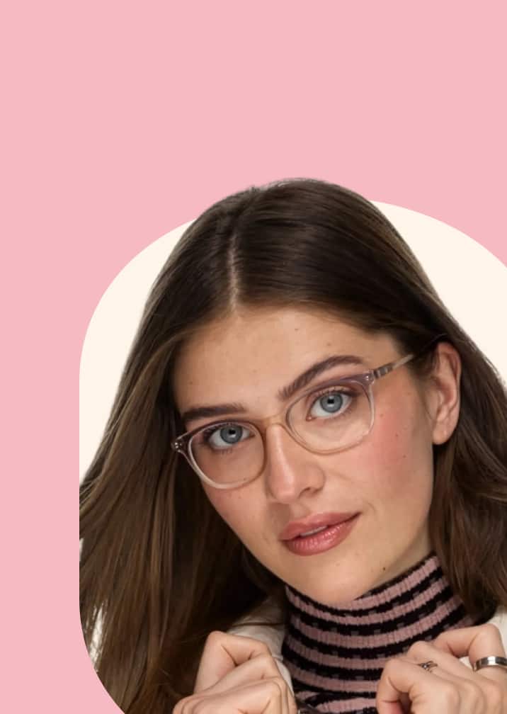 A woman with long light brown hair wearing translucent light pink glasses and a striped turtleneck, looking forward against a pink and cream cloud-shaped background.