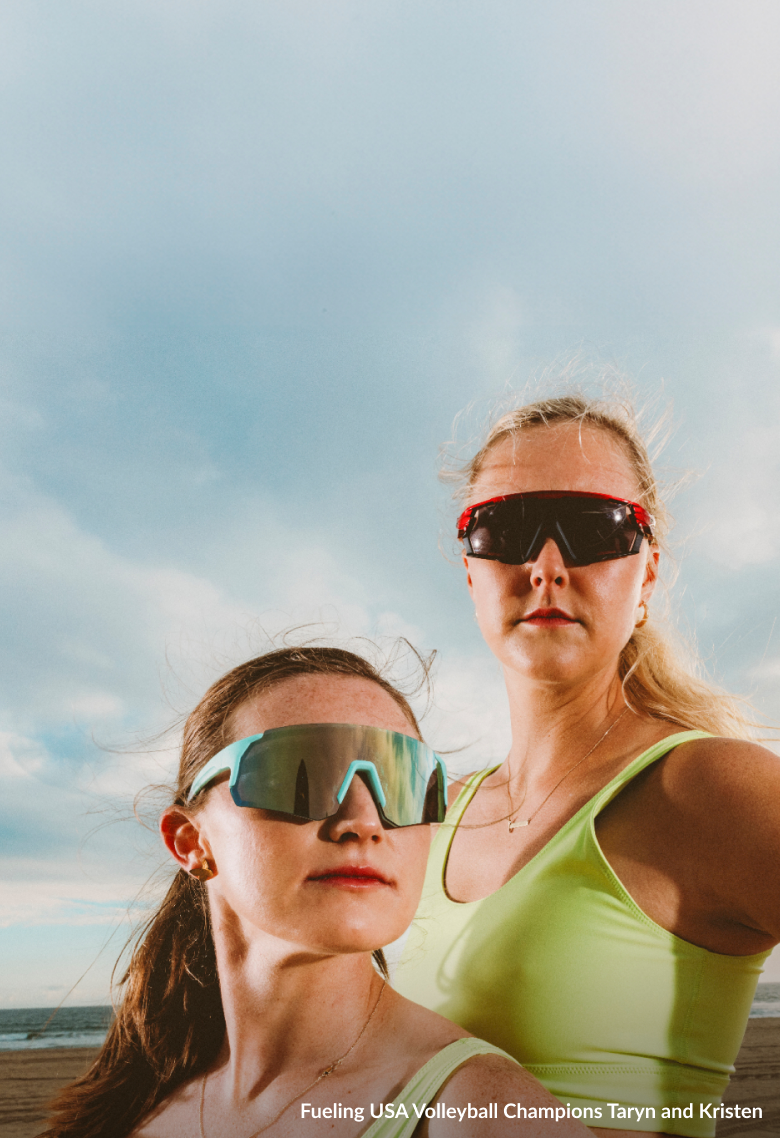 Taryn Kloth and Kristen Nuss wearing sports sunglasses on a beach, with the text 'Sports Sunglasses Built For Peak Performance' and options to 'Shop now' or 'Learn more.'