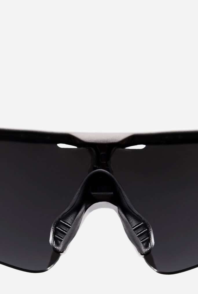 Close-up of adjustable nose pads on sports sunglasses providing a personalized fit and reducing slippage.