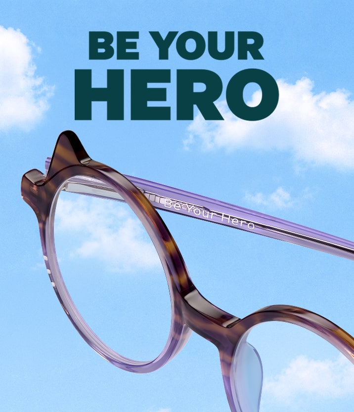 Tortoiseshell and purple round Zenni glasses engraved with "Be Your Hero," against a cloudy sky background.