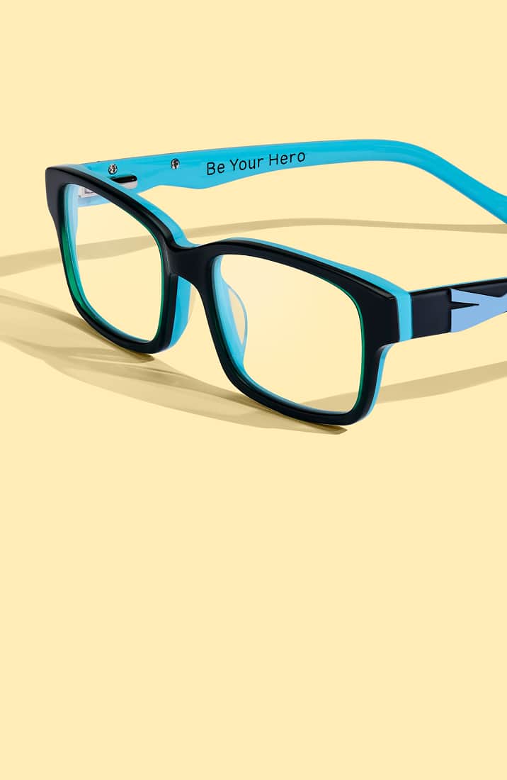 Black and blue kids' Zenni glasses engraved with "Be Your Hero" on the temple, on a yellow background.