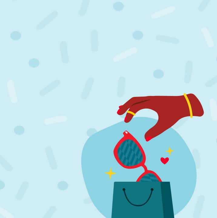 An illustration on a light blue background with faint sprinkles and dots. A dark red hand with gold jewelry is reaching down to place a pair of sparkly, red sunglasses with a small heart decal into a dark teal shopping bag.