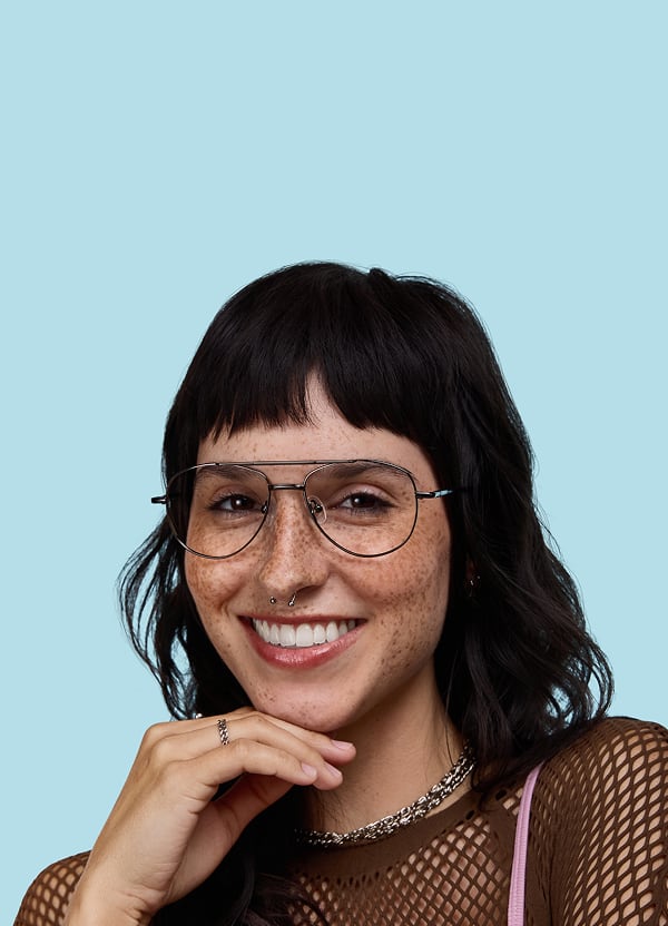 Person smiling while wearing wire-frame Zenni glasses