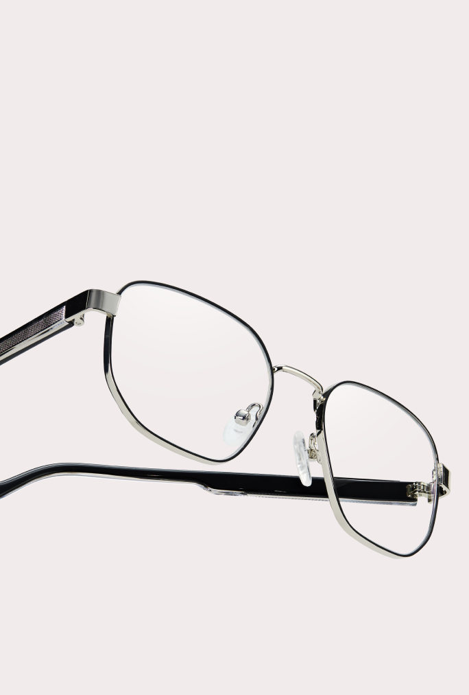 Close-up of Zenni metal frame glasses with rectangular lenses on a neutral background.