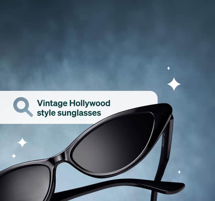 Sleek black cat-eye sunglasses floating against a textured slate blue background with illustrated sparkles, next to a search bar graphic that reads 'Vintage Hollywood style sunglasses'.
