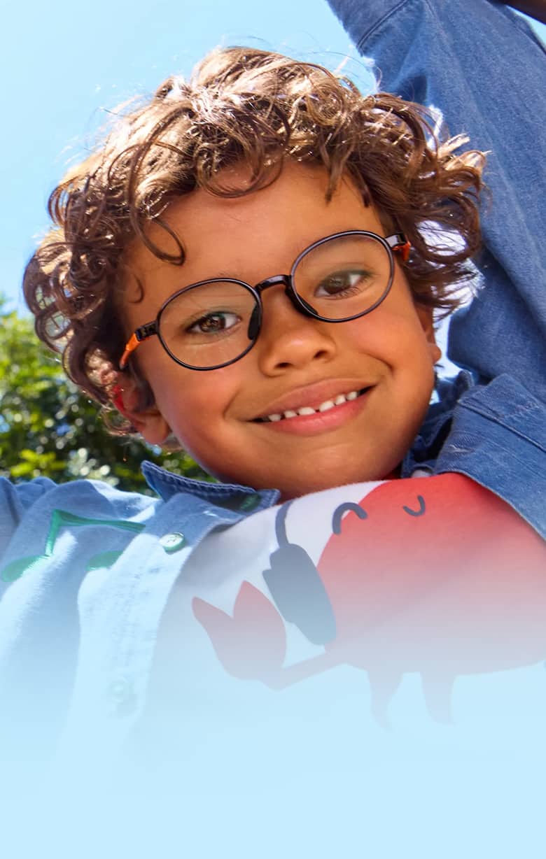 A girl with curly hair wearing pink glittery glasses, on a background featuring colorful shapes in pink, blue, green, and orange.