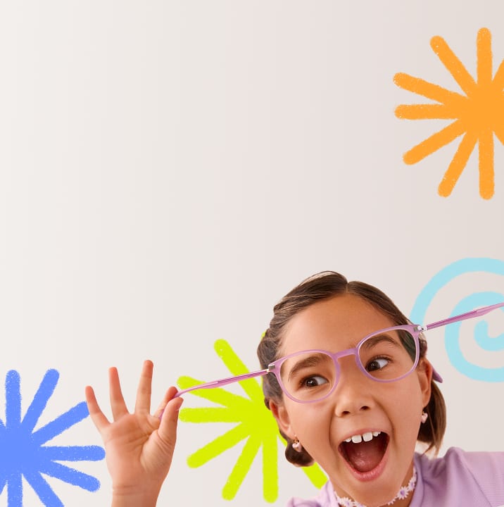 A young girl with pigtails excitedly stretches her pink glasses outward, wearing a lavender shirt and floral choker, with colorful blurred shapes in the background.