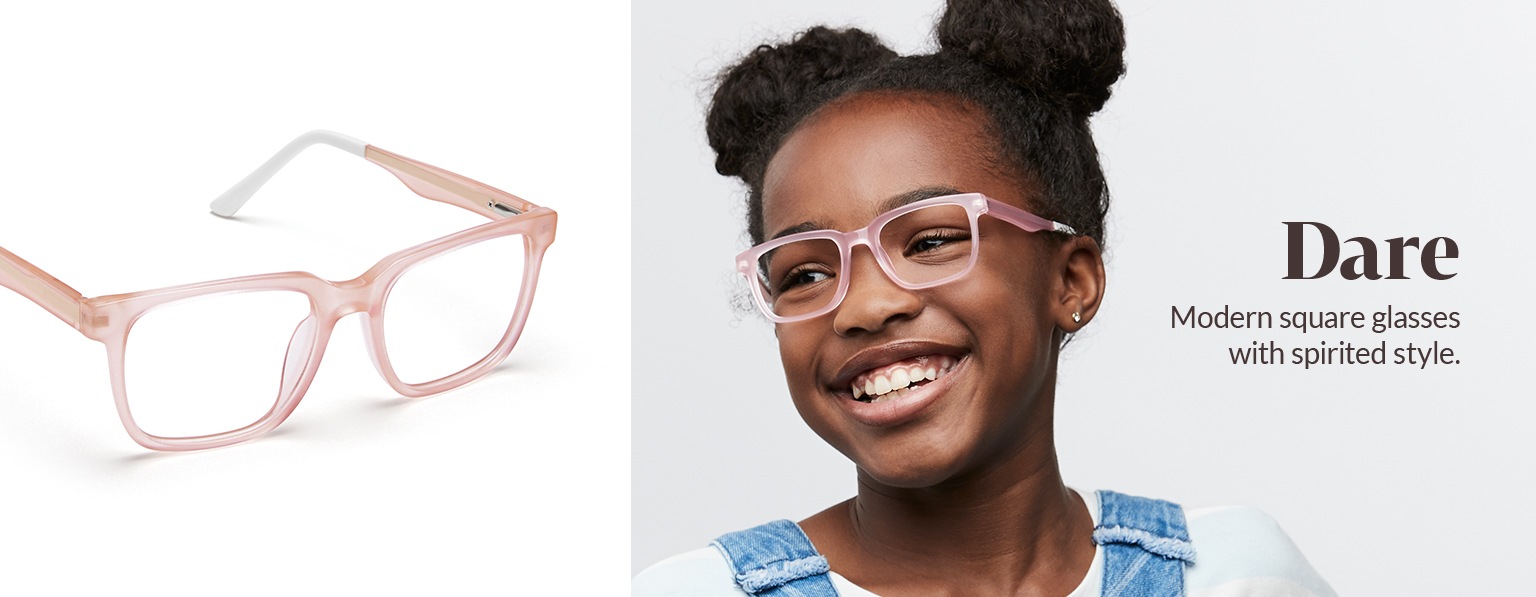 Girl with brown hair in pom-pom hairstyle wears Dare square glasses in blush #4440619 and denim overalls over white top.