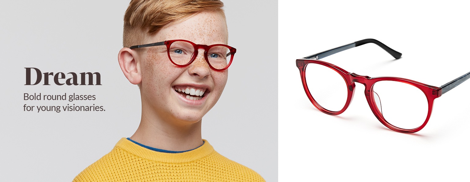Boy with red hair and freckles wears red Dream round glasses #4441518 and a yellow waffle-knit sweatshirt.