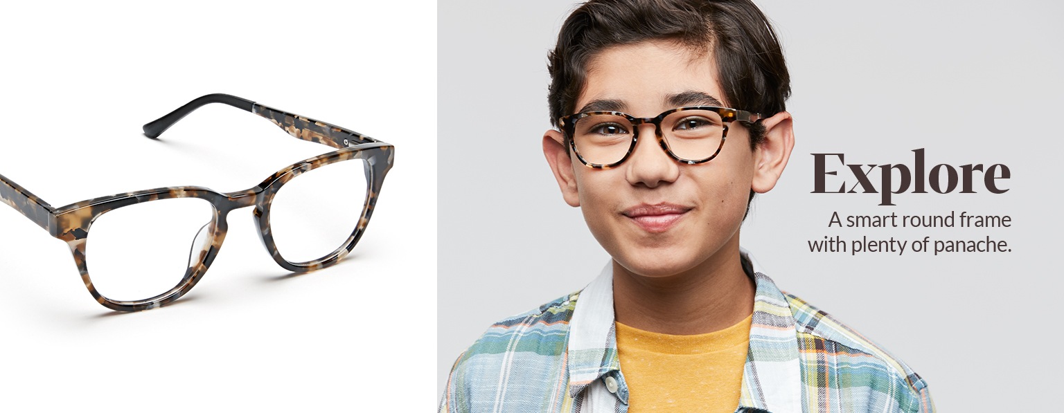 Boy with brown hair wears tortoiseshell Explore round glasses #4440935 with a pale madras shirt over a yellow tee.