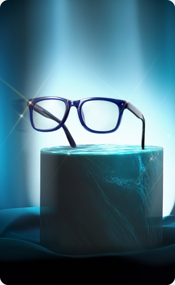 A sleek, modern pair of glasses sits on an elevated display, with cool lighting highlighting their elegant design.